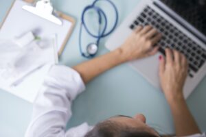 Female doctor working on laptop